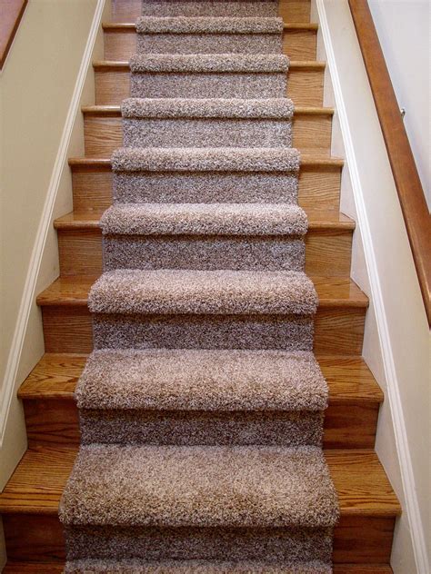 wood staircase with carpet runner.